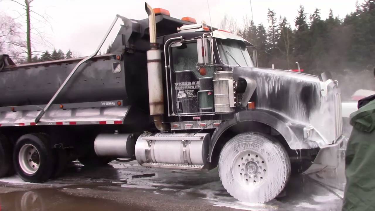 Commercial dump truck being pressure washed